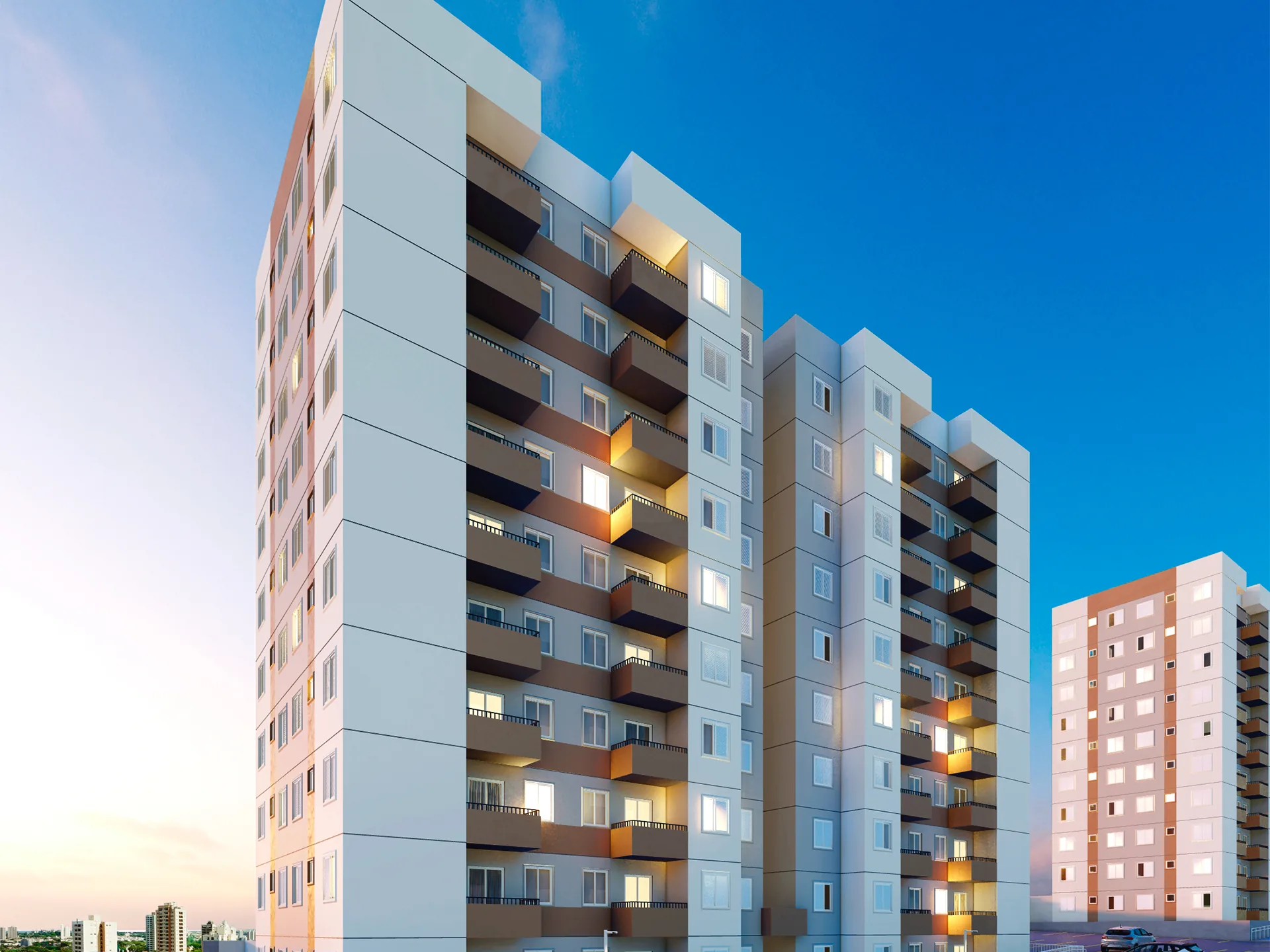 Torres residenciais do Cittrino Maringá iluminadas ao entardecer, com sacadas e estacionamento